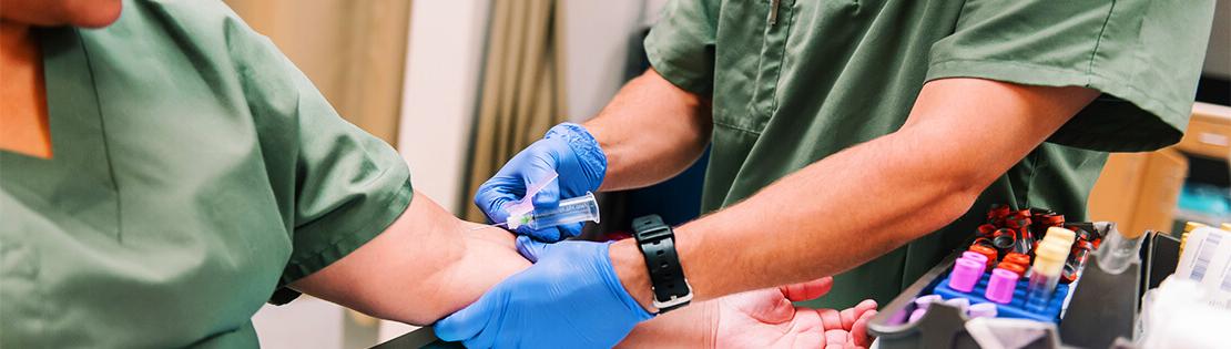 Two Pima phlebotomy students set up to practice in a Pima lab