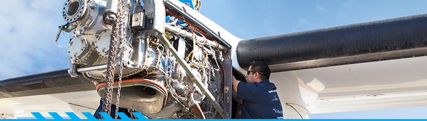 2 aviation program students working on airplane