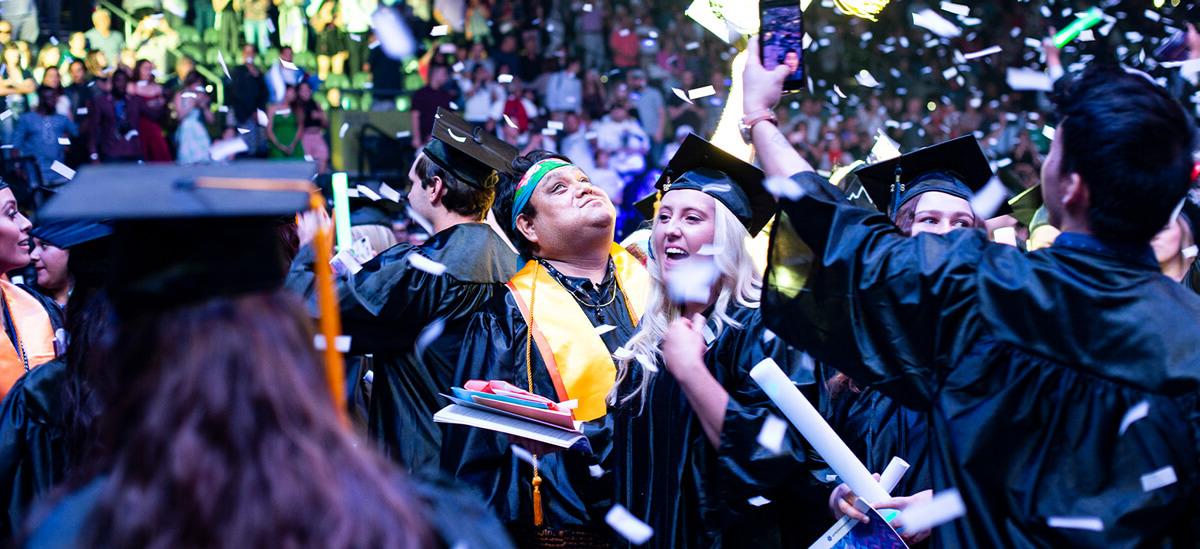 two people celebrate at a Pima graduation